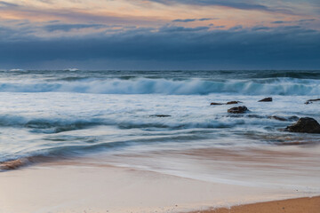 Cloud covered sunrise sesacape in soft pastel shades