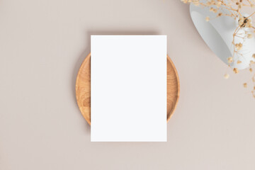Blank greeting card invitation Mockup 5x7 on envelope with dry flowers and ribbon on paper...