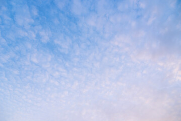 Blue sky background with white clouds.