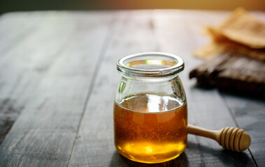 Honey with on wooden table background,  honey dipper