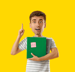 Funny office worker with big head holding folders on yellow background