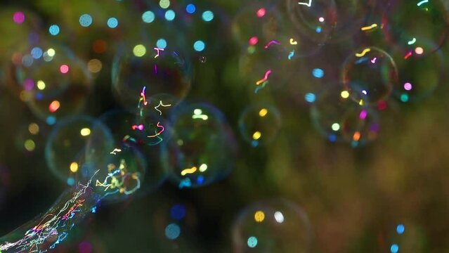 The soap bubbles float on a green background in the garden