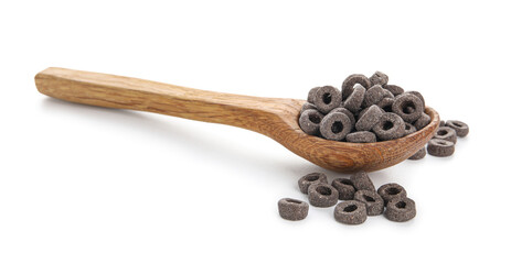 Wooden spoon with black cereal rings on white background