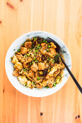 healthy plant-based food, vegan noodles stir fry with broccoli peas and marinated tofu chunks