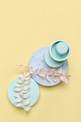 Showcase pedestal with floral decor on color background