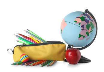 Yellow pencil case with school stationery, globe and apple on white background