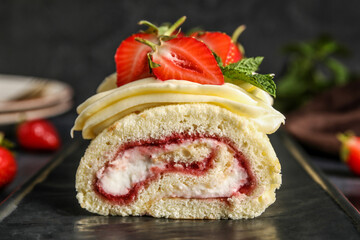 Board with tasty strawberry roll cake, closeup