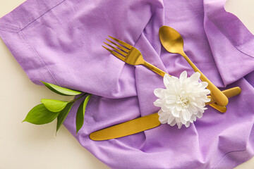 Obraz na płótnie Canvas Cutlery, napkin and chrysanthemum flowers on light background