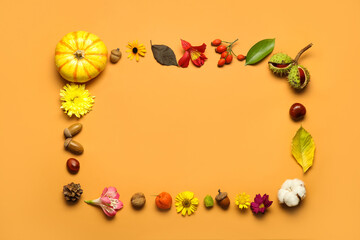 Frame made of natural forest decor, flowers and pumpkin on color background