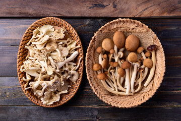 Asian edible mushroom in basket on wooden background, Table top view