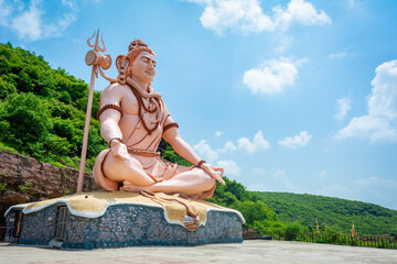 Hindu god Shiva sculpture sitting in meditation. Yoga and meditation concept.