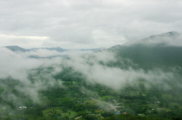 Fototapeta na wymiar green mountain top view with cloudy surrounding