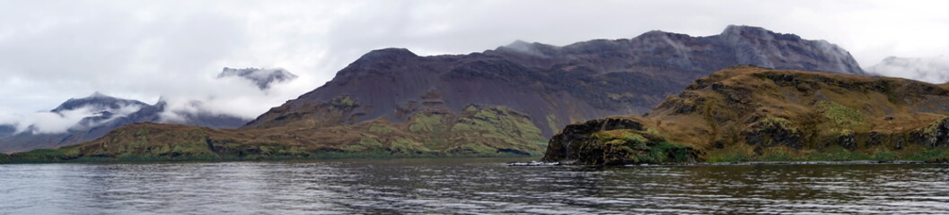 Panorama of mountains with a lush, green coastline on the South Atlantic, at Leith Harbor, South Georgia Island