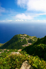 Fototapeta na wymiar Aerial view of Windwardside village from the Mount Scenery volcano on the Caribbean island of Saba in the Netherlands Antilles. Vertical view.