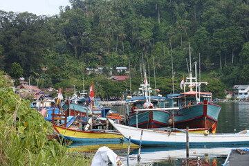 View of the river and boats and the activities of residents near the Siti Nurbaya Padang bridge, West Sumatra, Indonesia, Indonesia - May 21th 2022.