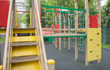 Fototapeta na wymiar Colorful playground in the yard in the park. Safe playground for children, MODERN COMPLEX