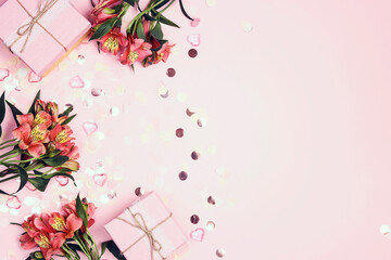 Romantic border of Alstroemeria flowers with confetti and gifts on pink background.