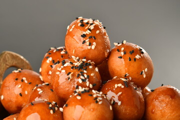 luqaimat or lokma. Freshly fried Lokma (luqma - arabic) piled high a popular middle eastern dessert of small dough balls deep fried then coated in sugar or honey syrup
