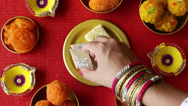 Kaju Katli Kaju Barfi Burfi cashew fudge candy woman hand serving Indian sweet mithai festival dessert Diwali Dussehra Holi ganesh chaturthi Ram navami Durga pooja Navratri Mumbai Kerala Sri Lanka