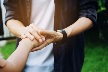 Two young lovers holding hands with blur backgroung