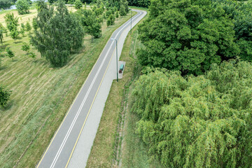 bike lane with footpath in summer park. landscape with green trees. aerial drone view.