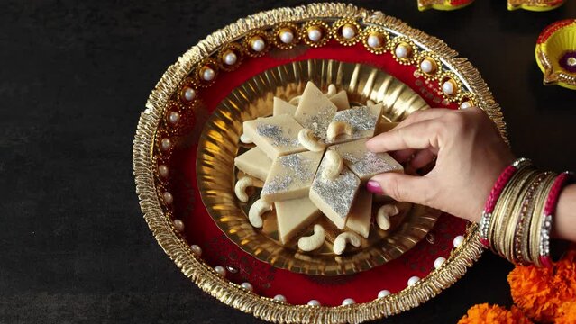 Kaju Katli Kaju Barfi Burfi cashew fudge candy woman hand serving Indian sweet mithai festival dessert Diwali Dussehra Holi ganesh chaturthi Ram navami Durga pooja Navratri Mumbai Kerala Sri Lanka