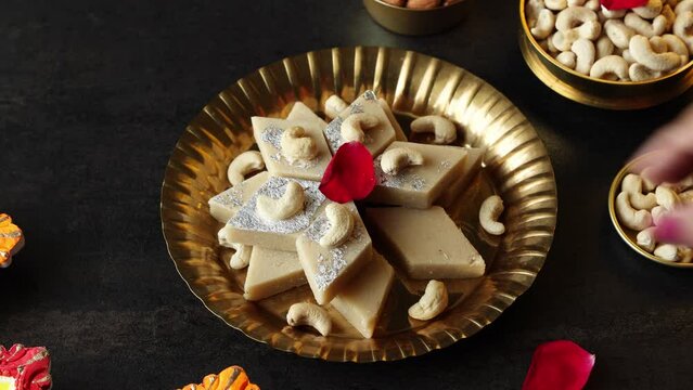 Kaju Katli Kaju Barfi Burfi cashew fudge candy woman hand serving Indian sweet mithai festival dessert Diwali Dussehra Holi ganesh chaturthi Ram navami Durga pooja Navratri Mumbai Kerala Sri Lanka