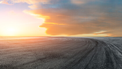 Fototapeta na wymiar Empty asphalt race track road with beautiful sky clouds at sunrise