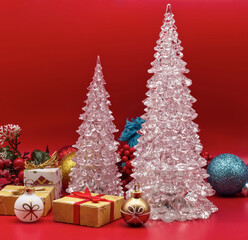 Fototapeta na wymiar Christmas Trees and Christmas decorations isolated on red background.