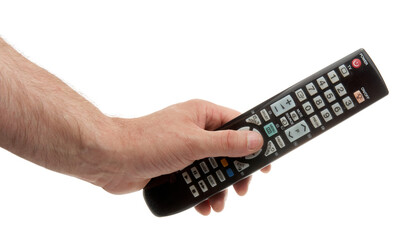 Changing TV program: close up of human hand holding television remote control isolated on white background