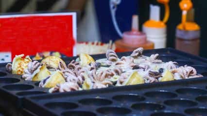 Takoyaki being prepared in Ho Thi Ky street food