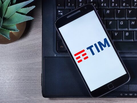 TIM logo on the smartphone screen. TIM (acronym for Telecom Italia Mobile) is a cell phone company based in Italy, also active in Brazil.