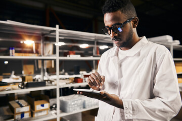 African engineer working with tablet at factory