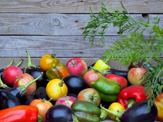 Autumn natural background. Fresh vegetables and fruits are stacked in a pile on a natural wooden background.Harvesting vegetables.