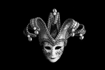 Venetian carnival mask on the black background. Close-up. Copy space.