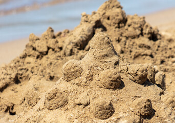 Children make sand houses on the beach.