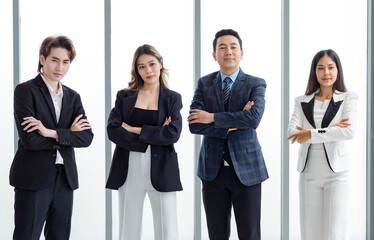 Full body shot of Millennial Asian successful professional male businessmen and female businesswomen in formal suit smiling posing look at camera walking side by side together in company hallway