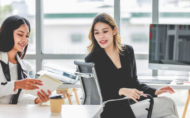 Millennial Asian pretty cheerful successful professional businesswoman in formal suit sitting at...