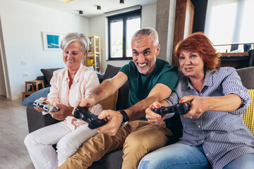 Group of middle age friends smiling happy playing video game at home.