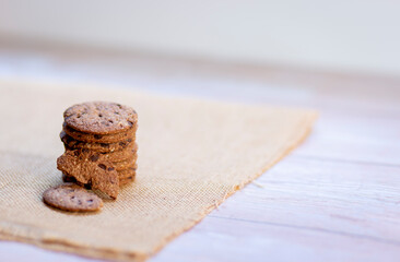Cookies stacked on a white table in the kitchen while eating breakfast.
