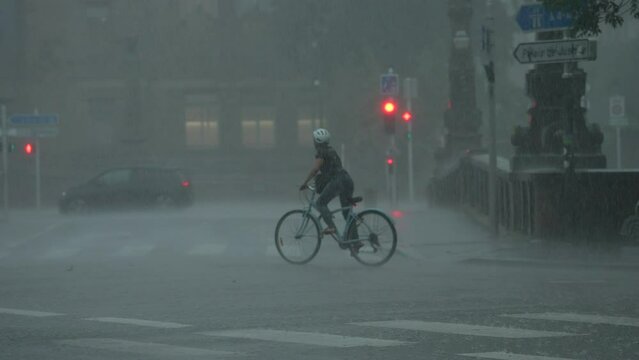 Man Cycling under the rain