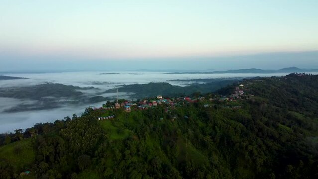 Aerial shot of the mountain Lushai Heritage Village and Sajek valley on a foggy day