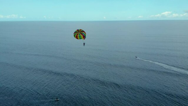 Aerial shot of the parasailing sport in the water of Cox's Bazar Sea Beach, Bangladesh