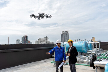 At construction site manager visit engineer working on the rooftop near pipe rack to inspection the...