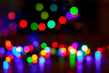 Abstract background with colorful sparkling bokeh on a dark background. Holiday concept