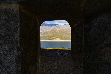 View of Fort Variselle at Lake Montcenis (Moncenisio) on the border between Italy and France. Old ancient historical fort ruins in stone in the Alps mountains