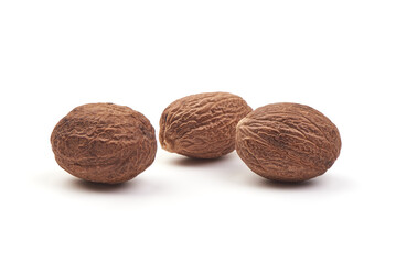 Fresh Nutmeg. Whole nuts, close-up, isolated on white background.