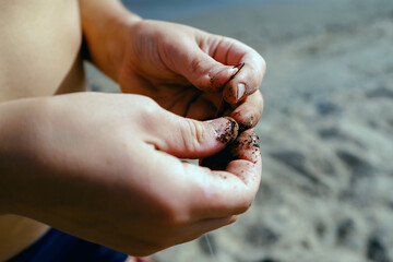 fishing skills concept. a fisherman puts a worm on a hook close-up