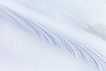 White abstract background of snow crust on the ice of a frozen lake. Natural beautiful snow pattern. Winter backdrop for design, text, announcement or advertising, blank, mock up