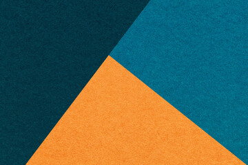 Texture of craft navy blue, cerulean and orange shade color paper background, macro. Vintage...